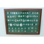 A large framed display of British army anodised aluminium / Staybrite cap badges