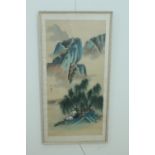 A Chinese watercolour painting on fabric of mountain dwellings and rocky outcrops, framed under