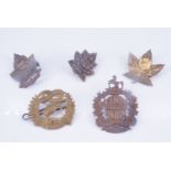 A Canadian 1st Hussars cap badge, two Great War Canadian Expeditionary Force collar badges and a 4th