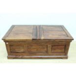 A contemporary Asian panelled hardwood combined coffee table and chest, its top comprising a pair of