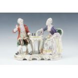 An East German porcelain figure group by Rudolph Kammer, a gentleman and lady playing chess,