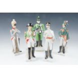 A set of four kitsch porcelain Napoleonic soldier figurines, together with one other, similar,