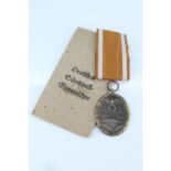 A German Third Reich West Wall Medal and packet