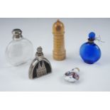 Five early to mid 20th Century scent bottles comprising, Lalique "Worth" blue glass example, an