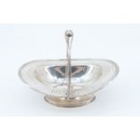 An Edwardian silver swing handled bon-bon dish, being of oval shape and having a reticulated