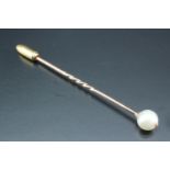 A late 19th / early 20th Century yellow metal stick pin having a pearl terminal, latter 7 mm, 1.3 g