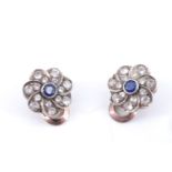 A pair of sapphire daisy earrings, each having a central 0.15 carat brilliant cut blue sapphire in a