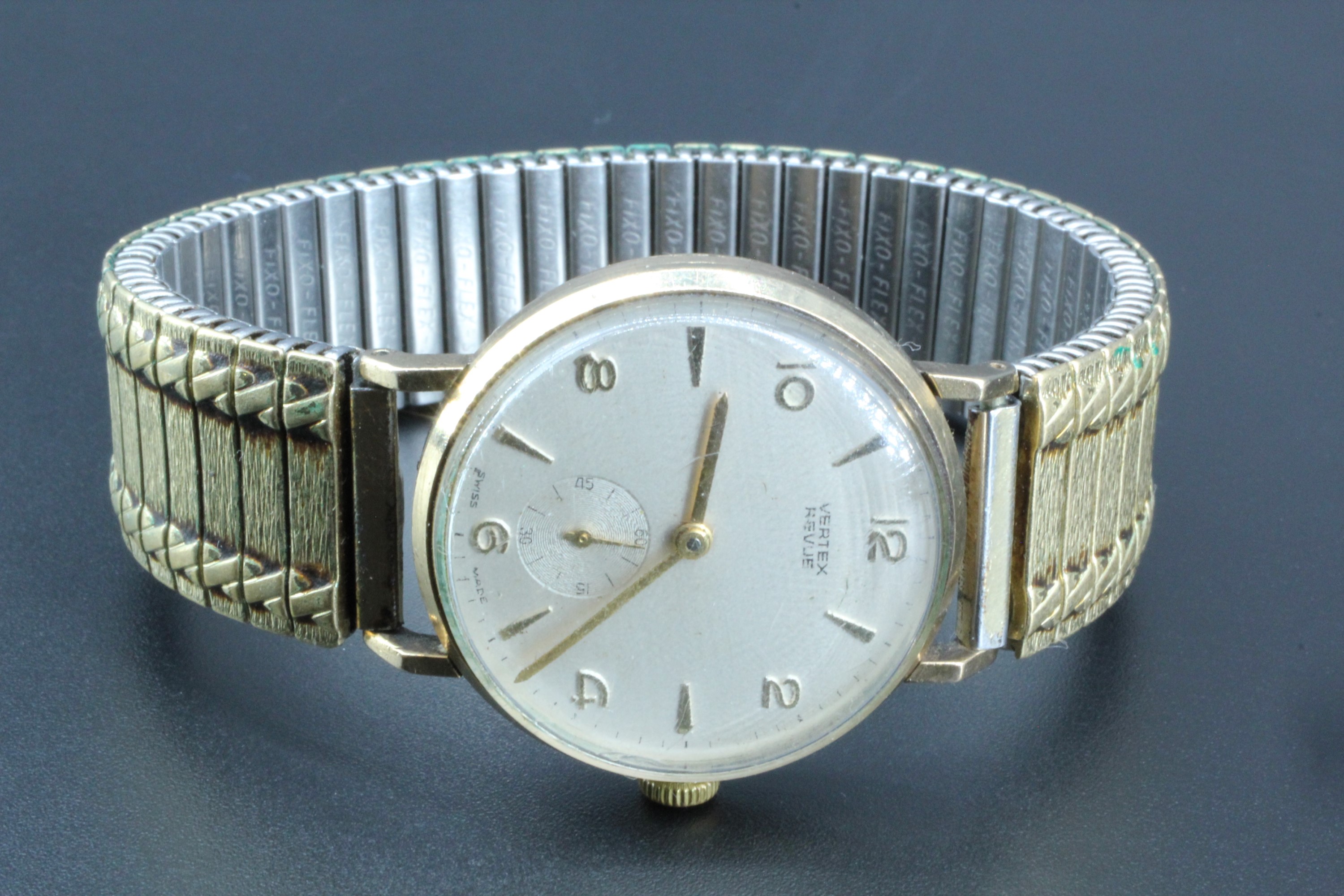 A Vertux 9 ct gold "Revue" wristwatch, having a 17 jewel movement, its frosted silver face having