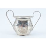 An Edwardian silver sugar basin, of diminutive size and having bright cut ribbons and swags