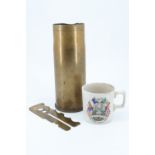 A brass shell case together with a Great War button stick and a Bedwas and Machen 1919 "Peace" mug