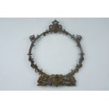 An early 20th Century neo-Baroque cast brass dinner gong frame, decorated with satyrs and scrolls,