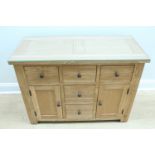 A contemporary oak sideboard, having a glass top, 110 cm x 50 cm x 81 cm