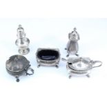 A George V silver condiments set, comprising salt cellar, pepperette and mustard pot of 18th Century