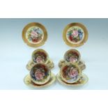 A set of six Aynsley teacups, saucers and side plates, gilt exteriors and decorated with roses by