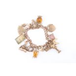 A 9 ct gold charm bracelet, being a double curb link with eleven 9 ct gold charms, two yellow