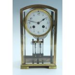 An early 20th Century French brass mantle clock, having a drum movement with a mercury pendulum,