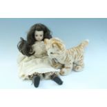 A 20th Century bisque headed doll, having glass eyes, together with a Steiff kitten, former 50 cm