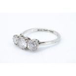 A three-stone diamond ring, comprising a central brilliant cut stone of approx 0.5 ct flanked by
