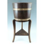 An early-to-mid 20th Century coopered oak jardiniere stand, 31 cm x 69 cm high