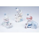 Three Lladro figurines of clowns / children with puppies, tallest 15 cm