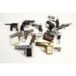 A quantity of vintage novelty gas cigarette lighters in the form of a gun / pistol, including two