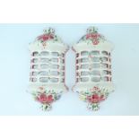 A pair of modern floral decorated faience wall light covers, 17 x 8 x 34 cm
