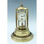 A large lacquered brass torsion clock, comprising a cylindrical movement with a disc pendulum and