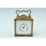 An early 20th Century brass carriage clock, key wind and set, having an architectural case with