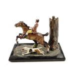 A 1950s novelty cigar / table lighter, formed as a cold painted spelter model of a jumping