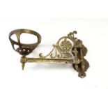 An early 20th Century Aesthetic influenced cast brass, hinged, oil lamp bracket, 31 cm from wall