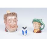 A Royal Doulton small Toby jug, a Beswick Toby jug No.1117, and a miniature Toby jug.