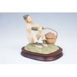 An early limited edition Border Fine Art figurine of a clown sat beside a large basket of