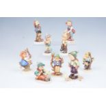 Nine Hummel figurines including Little Helper, Little Fisherman, Lets Play, and Winter Adventure, 12