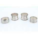 A pair of 1920s silver napkin rings, together with two other silver rings, 69 g