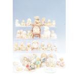 A large quantity of Cherished Teddies figurines, together with four Cherished Teddies wall plaques