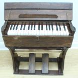 An early 20th Century portable / folding reed organ of a type commonly seen used during the Great