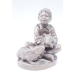 Pauline Parsons, a cold-cast bronze figurine of a boy sat with two pet rabbits, 13 cm