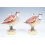 A near pair of Spanish Alcora faience sauce tureens in the form of partridges, the lift off covers