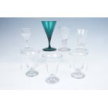 A group of Georgian glass including an emerald wine glass of drawn trumpet form CF