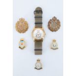 An RAF commemorative wristwatch together with cap and squadron badges