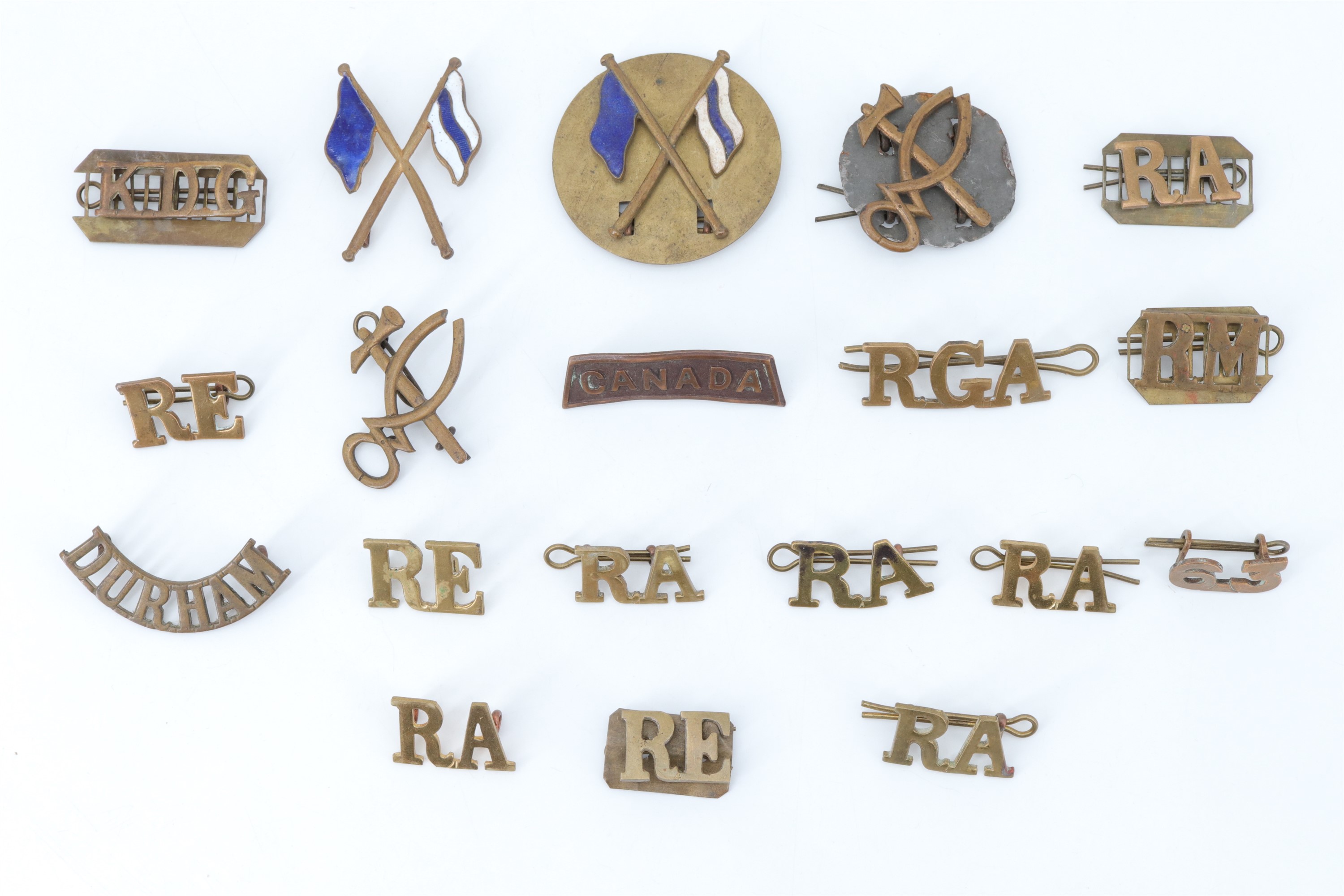 A small group of British and Canadian army metal shoulder titles and qualification badges