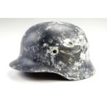 A German Third Reich Model 1935 steel helmet shell, stamped ET 65