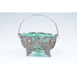 A late 19th / early 20th Century electroplate Rococo swing handled basket with green glass liner, 12