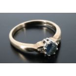 A sapphire and diamond dress ring, the oval cut sapphire of approx 0.5 ct claw set between small