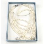 A boxed three string cultured pearl necklace, having a hook clasp, together with another similar