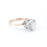 A flamboyant white gemstone solitaire ring, the brilliant of approx 9 mm diameter crown set on a 9