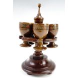 A wooden stand and Tunbridge style egg cups