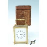 An early 20th Century leather cased brass carriage clock, the clock having brass sides and back,