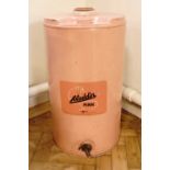 A large Aladdin pink paraffin dispensing tin, 35 cm x 63 cm