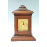 An early 20th Century post box form walnut mantle clock, having a French drum movement, striking